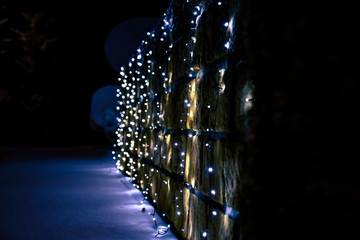 christmas lights on a stonewall