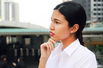 Young Asia business woman smile portrait and offices building background.