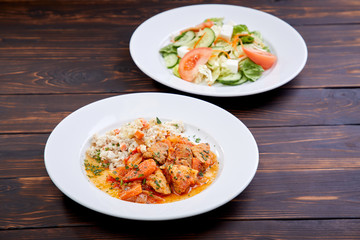 meat with barley and salad on the wooden background