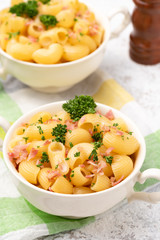 macaroni cheese with bacon on white backdrop 
