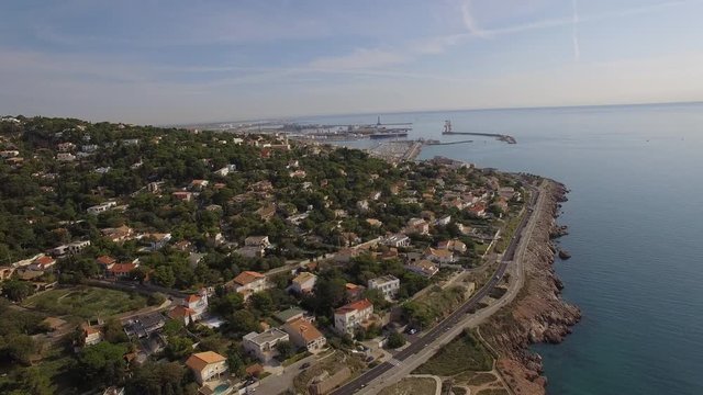 Aerial shot discovering Sete, south of France, above the Mediterranean Sea. Camera is moving forward.2/2