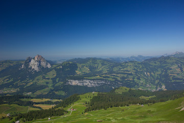 view over swiss mountains under blue sky