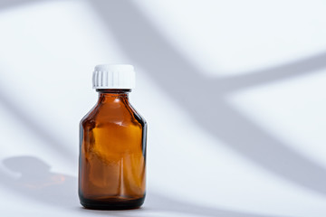 empty brown glass medical bottle on white background