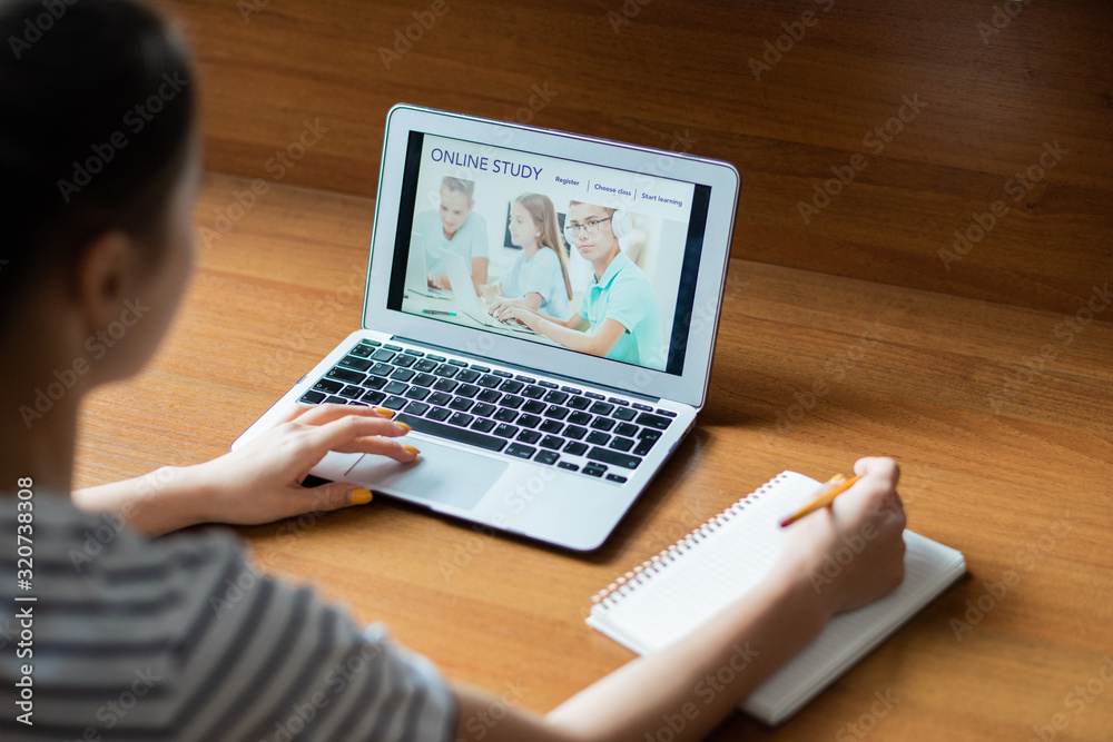 Poster teenage girl entering educational website while scrolling through homepage with image of schoolkids 