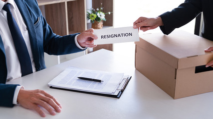 Employee businessman submit or sending resignation document letter to human resource manager or boss, Change of job, unemployment, resign concept.