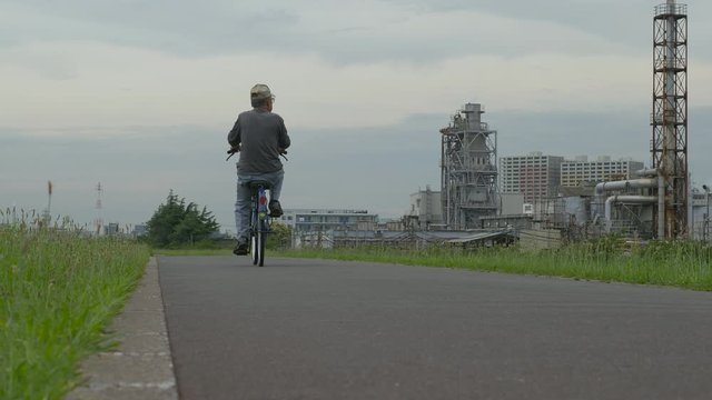 man cycling on the road