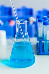 Medical diagnostic laboratory. Samples of the material for testing and reagent in a laboratory flask.