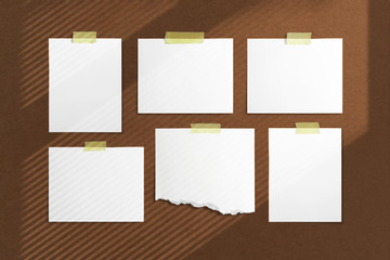 Mood-board composition template with blank photo cards, polaroid frames glued with yellow adhesive tape and on brown desk with geometric  shadow overlay.