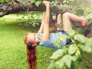 friendship, childhood, leisure and people concept - happy smiling little redhead girl hanging...