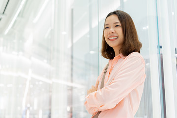 close up asian adult businesswoman crossing arm and looking forward with visionary inside office background for international women's day and empower inspirational people concept