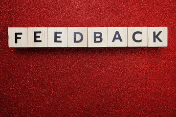 Obraz premium Feedback alphabet letter with space copy on red glitter background