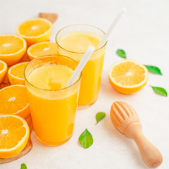 fresh orange Juice and oranges on the cutting board