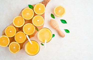 fresh orange Juice and oranges on the cutting board