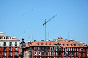 crane and buildings against blue sky