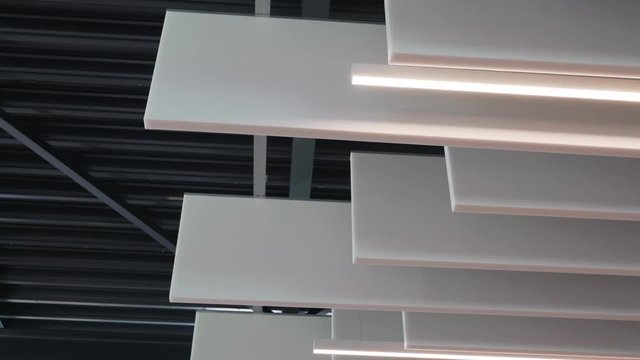 White rooftop ceiling tiles with sound absorber and lights