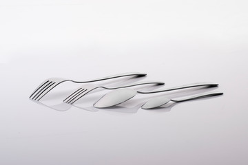 Fototapeta na wymiar Utensils (forks and spoons) on a white background. Product photography.