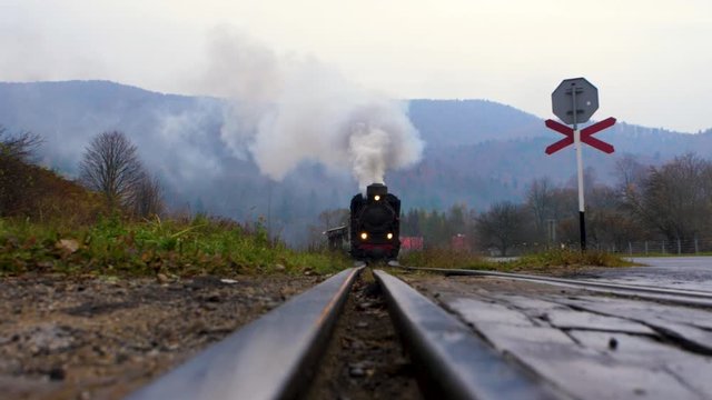 Approaching narrow gauge railway (locomotive) with the mountain view in the background