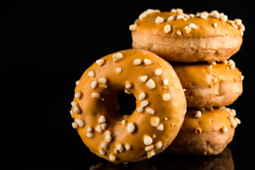 Stack of  Salted Caramel Donuts or Doughnuts on Black Background with Copy Space