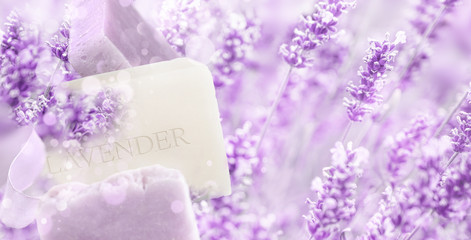 Natural lavender soap bars on blooming Lavender field background. Soft focus, mixed media.