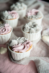 Fototapeta na wymiar Tasty homemade cupcakes. Vanilla muffin cupcake with cream buttercream icing. Birthday cupcake. Valentine sweets. Close up view delicious sweet dessert