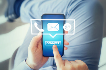 Close-up image of male hands using smartphone with icon telephone email mobile phone and address. Contact us connection and e-mail marketing concept
