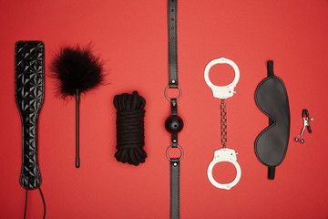 top view of black sex toys isolated on red