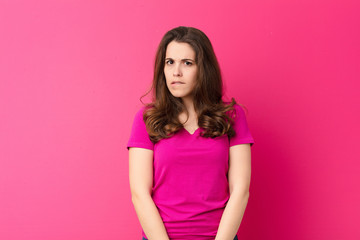 young pretty woman feeling clueless, confused and uncertain about which option to pick, trying to...