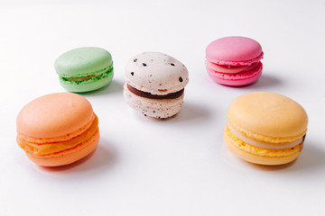 Macarons pattern on white background. Colorful french desserts. Top view. Flat lay