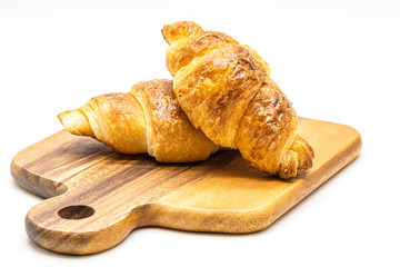 Close up fresh of  croissant on wooden tray isolate on white background.