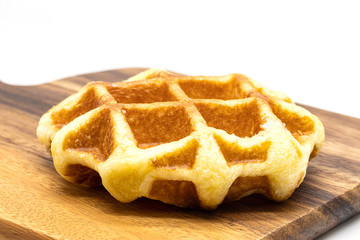 Close up fresh of  waffles on wooden tray.