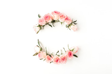 Round frame border of pink rose flower buds on white background. Mockup blank copy space. Flat lay, top view floral composition.