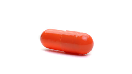 orange capsule isolated on a white background. medical capsule