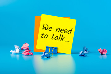 We need to talk. Note on blue background. notification of a serious conversation