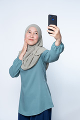 Woman taking selfie with her mobile phone.