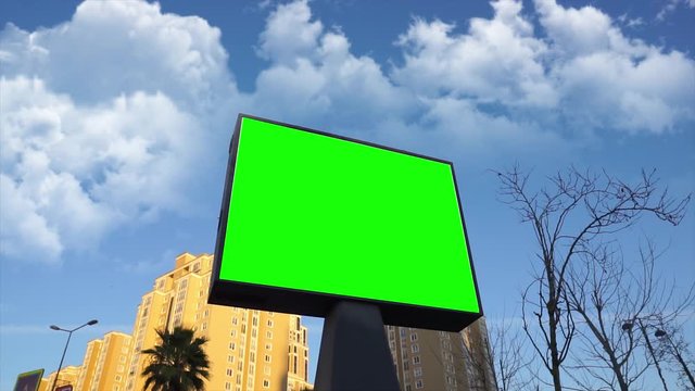 Green screen billboard on urban, city life. Blank advertisement panel, banner for marketing. Chroma key empty sign.