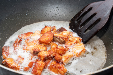 Fried salmon in a frying pan