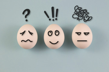 Chicken eggs with different emotions of joy, anger, indifference, anger. on a blue background....
