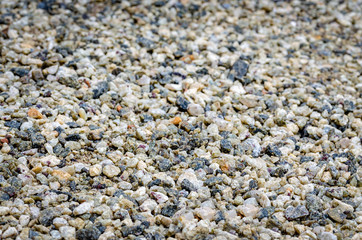 Multi-colored, smooth pebbles on the ground as a background.