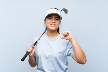 Young golfer Asian girl over isolated blue background proud and self-satisfied