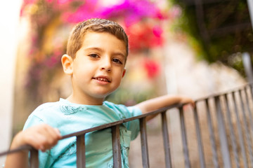 Portrait of a cute child holding a railing