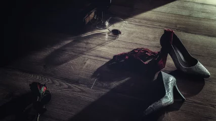 Low key photography of red wine glasses and rose with high heel and panties thrown on the floor  romantic erotic lovers night © Lupsa Florin