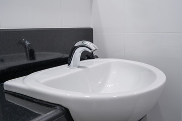 Modern faucet and white ceramic washbasin sink bathroom interior building decoration