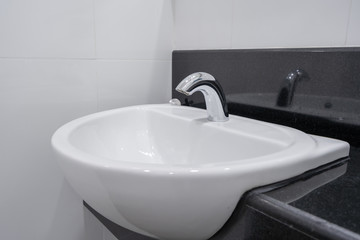Modern faucet and white ceramic washbasin sink bathroom interior building decoration
