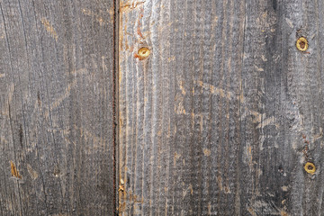 Background design. Wooden fence made of old boards with the inclusion of knots, resin and remnants...