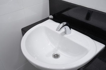 Modern faucet and white ceramic washbasin sink bathroom interior building decoration
