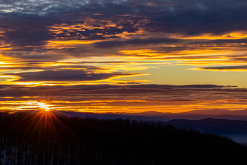 Fototapeta premium Spectacular sunset sky over the mountain, snowy winter view from the Kopitoto Hill, Vitosha Mountain, Sofia, Bulgaria