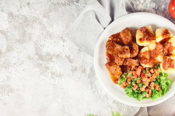 Braised pork meat stew served with potatoes