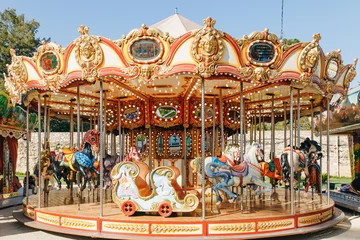 Deurstickers children's carousel in the park of attraction © Ksenia