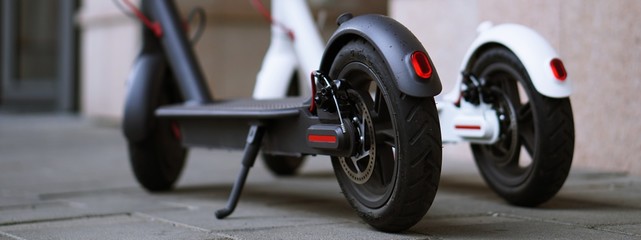 Modern electric scooter parking on the street. © Nataly