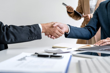 Teamwork partnership meeting concept, Two confident Business shaking hands after discussing good deal of trading contract and new projects for both companies